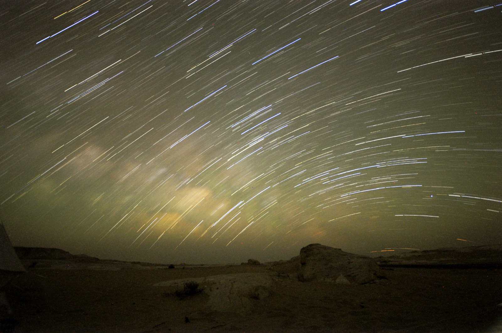 Star trails circling above chalk formations in Egypt's White Desert